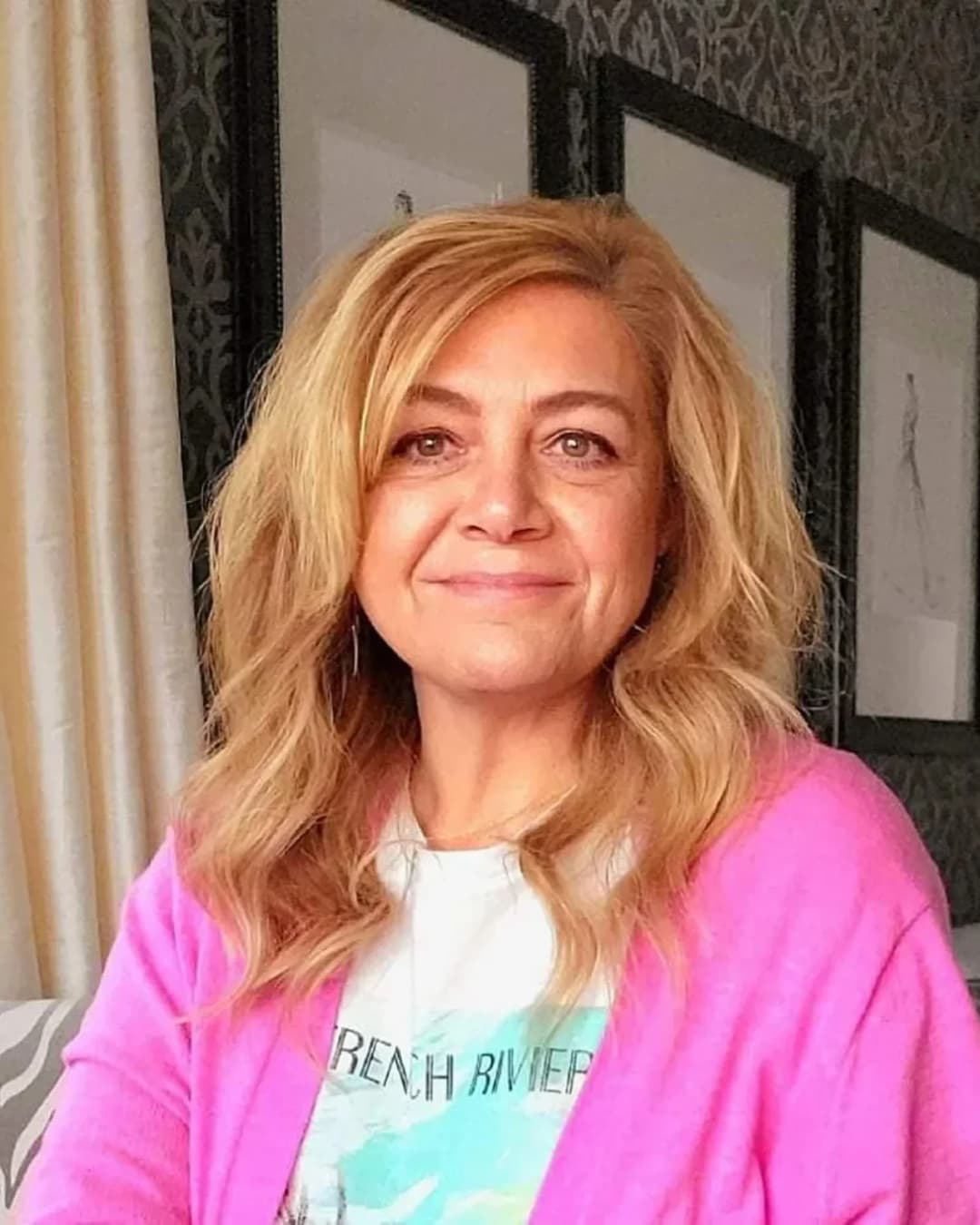 Becky, founder and creative director of Revel &amp; Rare Occasions, smiling in a pink cardigan